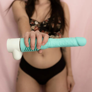 woman holding velvet thruster prime model adult toy with jackie silicone top in mint green and base in white